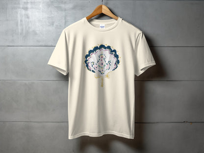 Cream t-shirt with a seashell graphic featuring blue, pink, and green details.