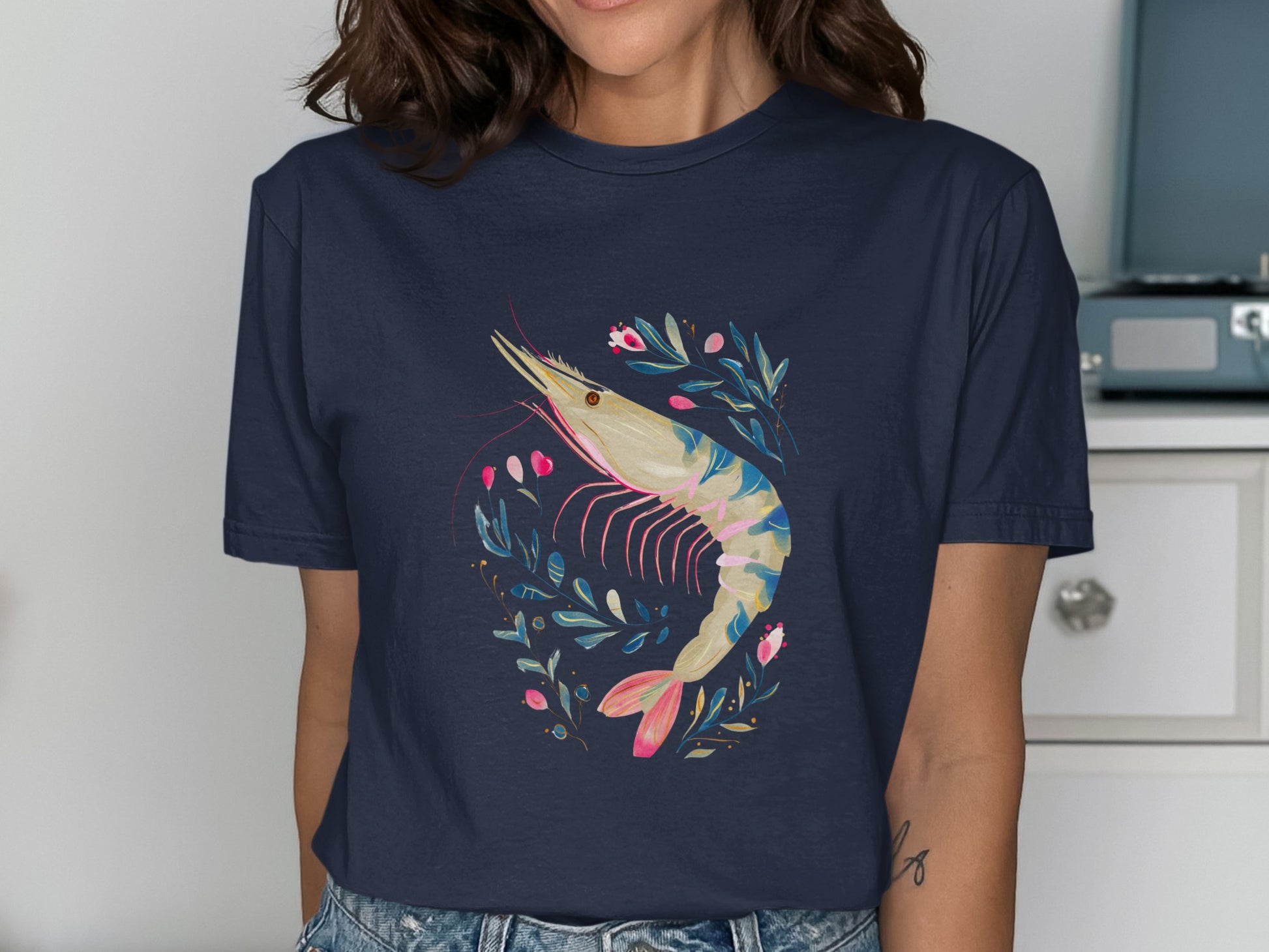 Navy t-shirt with a stylized shrimp and floral wreath graphic.
