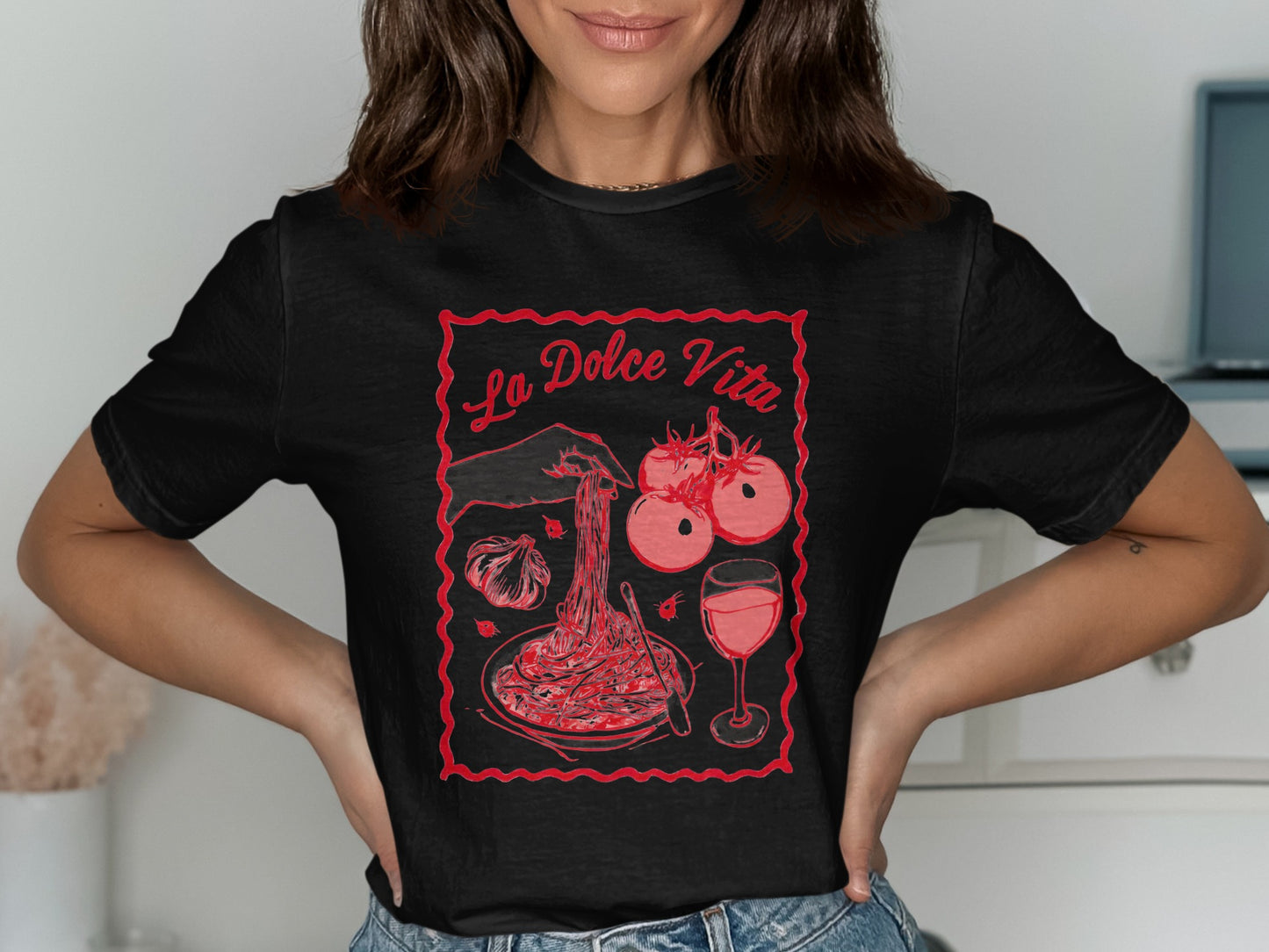 Black t-shirt with "La Dolce Vita" text and graphic of pasta, tomatoes, and wine.