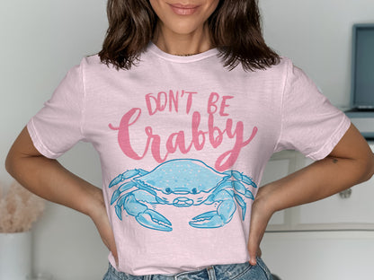Pink t-shirt with a blue crab graphic and "Don't Be Crabby" text.