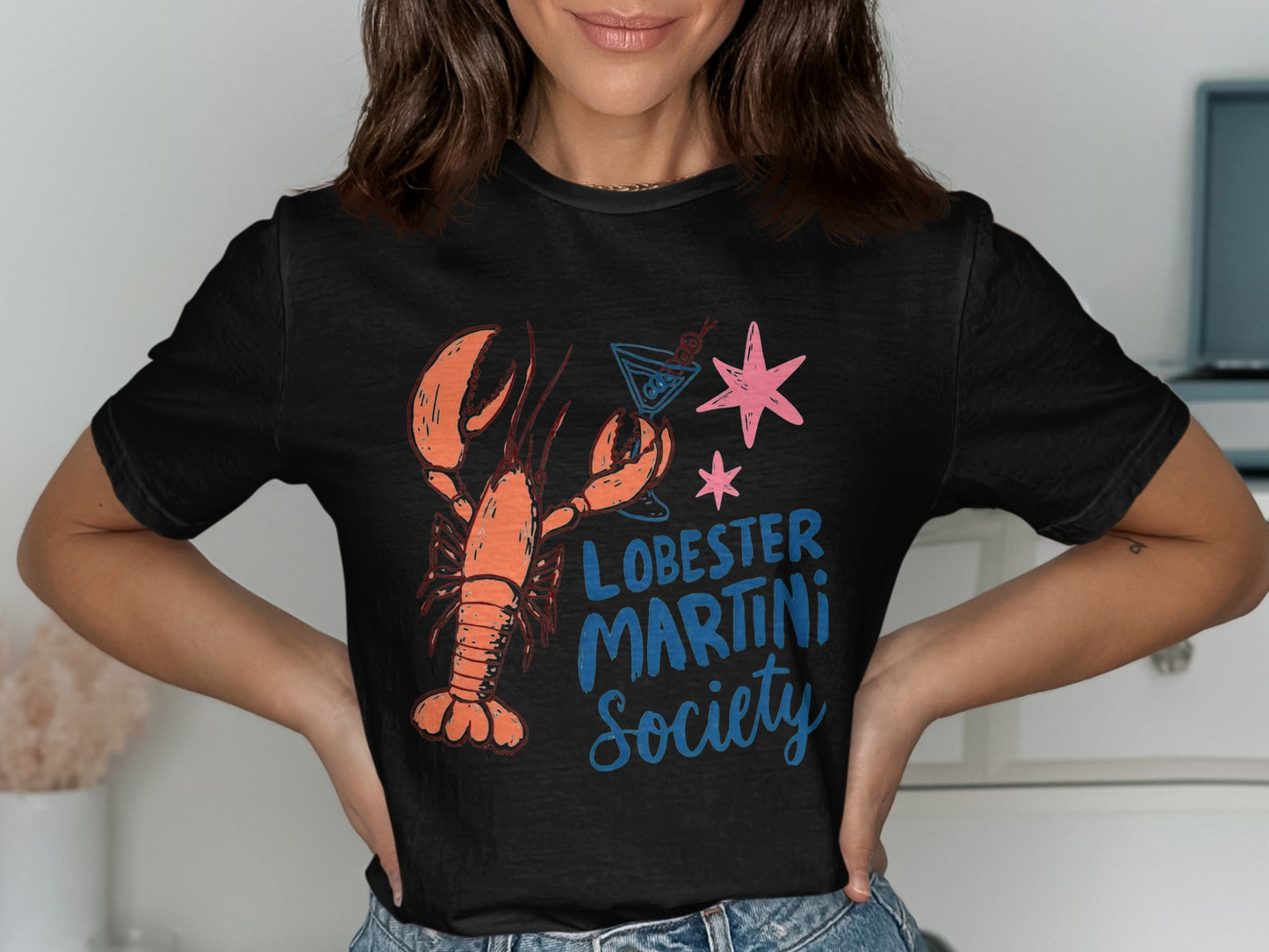Black t-shirt with lobster, martini, and star design and text "LOBSTER MARTINI SOCIETY".