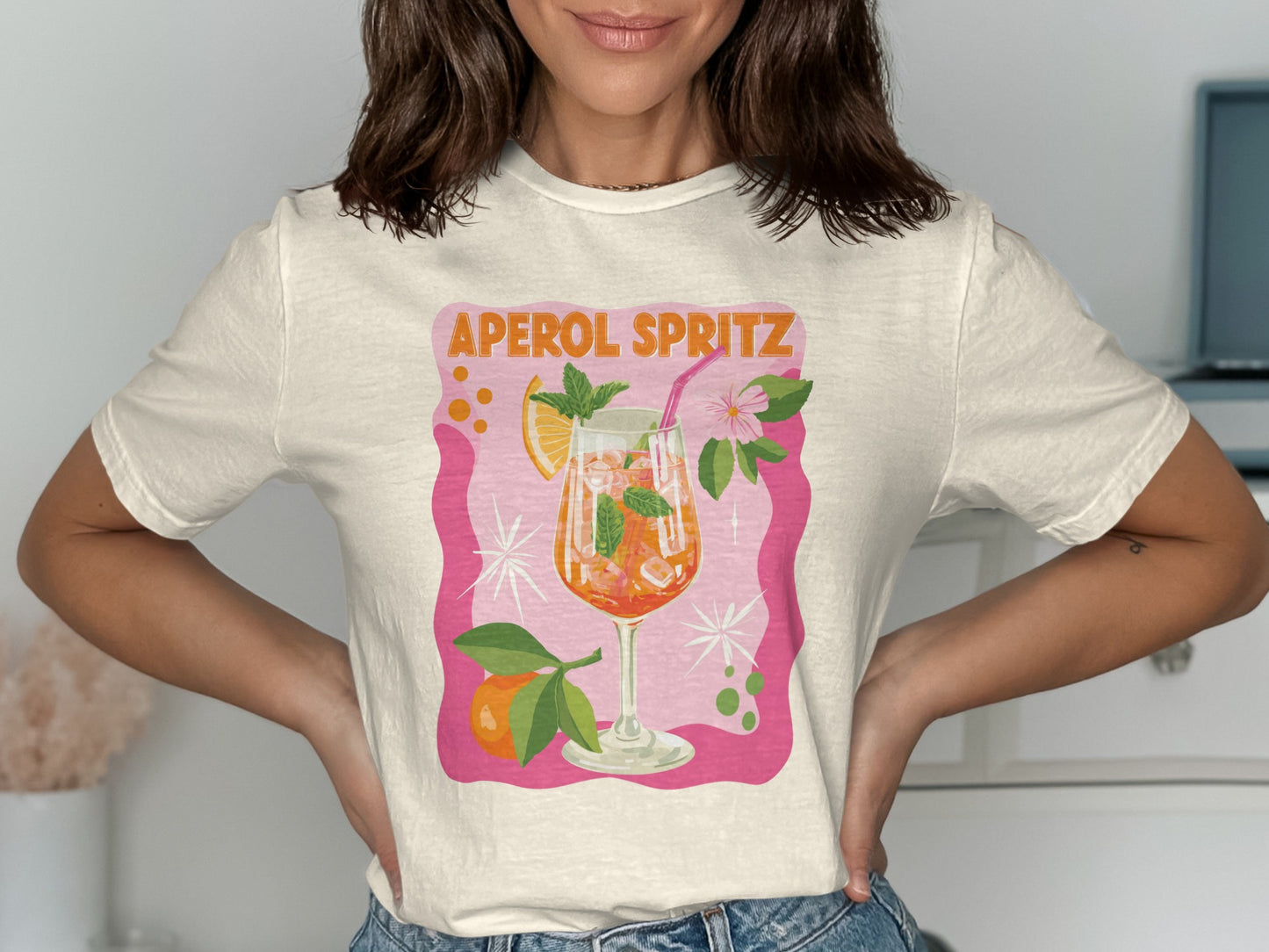 White t-shirt with "Aperol Spritz" text and a glass of Aperol Spritz.