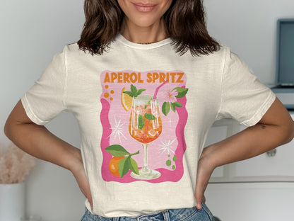 White t-shirt with "Aperol Spritz" text and a glass of Aperol Spritz.
