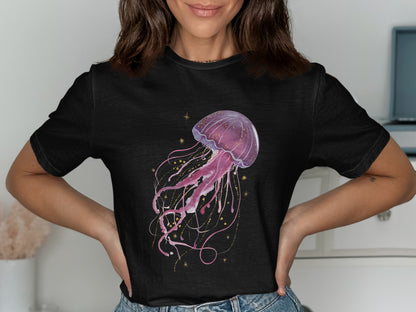 Black t-shirt with a watercolor illustration of a pink jellyfish and gold stars.