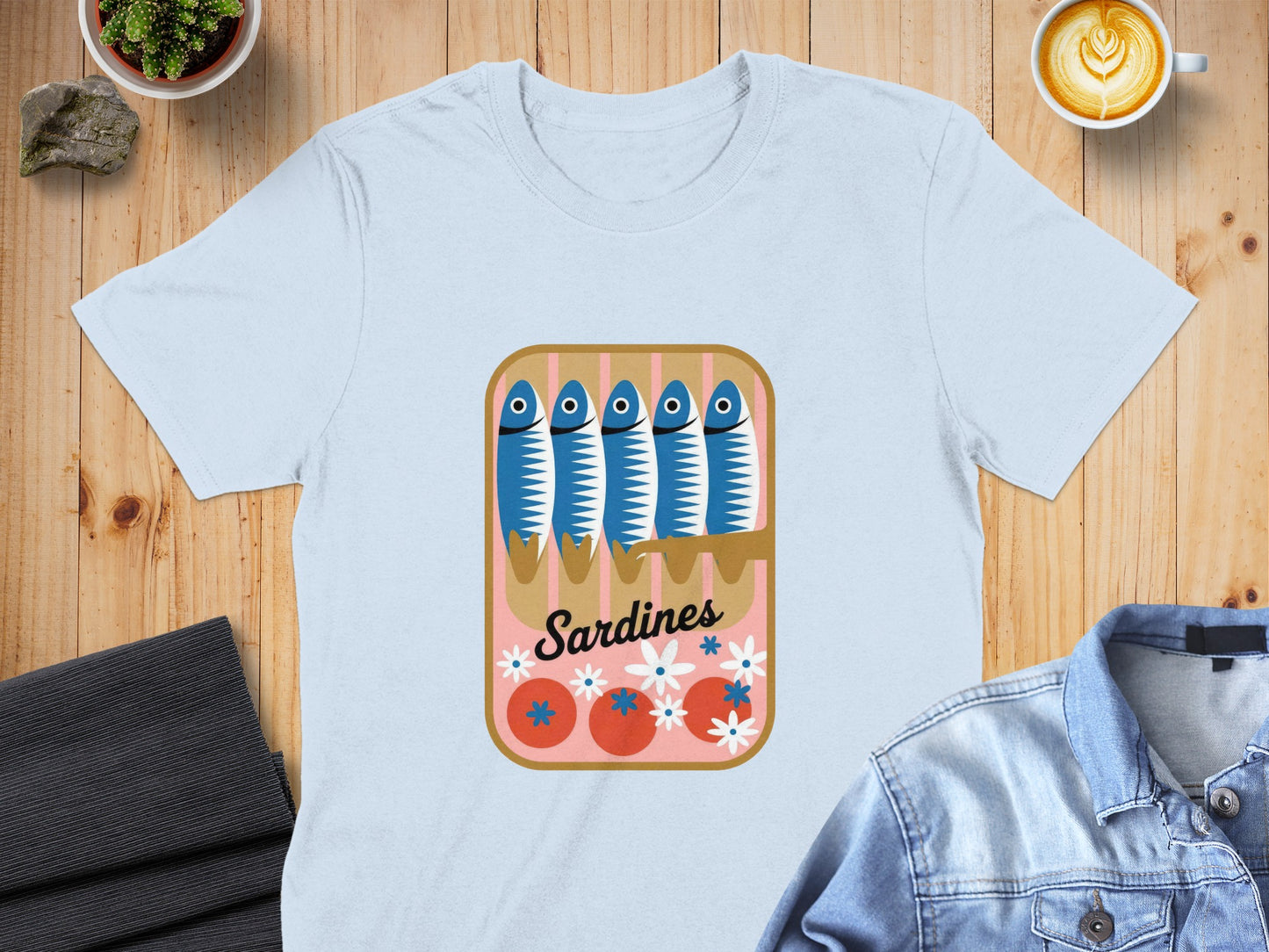 Light blue t-shirt with cartoon sardines in an open can graphic.