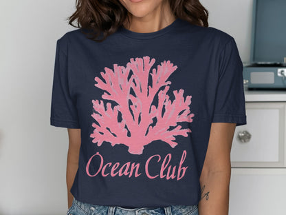 Navy t-shirt with pink coral graphic and "Ocean Club" text.
