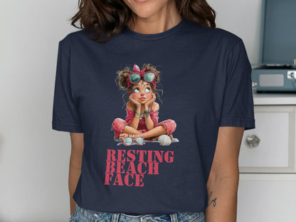 Navy t-shirt with illustration of girl wearing sunglasses and "RESTING BEACH FACE" text.
