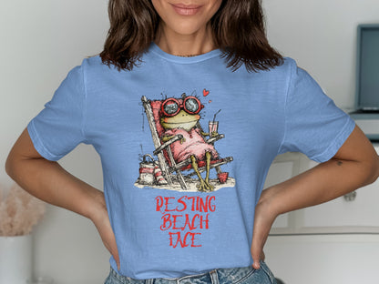 Light blue t-shirt with graphic of frog in beach chair, text reads "Pestting Beach Face".