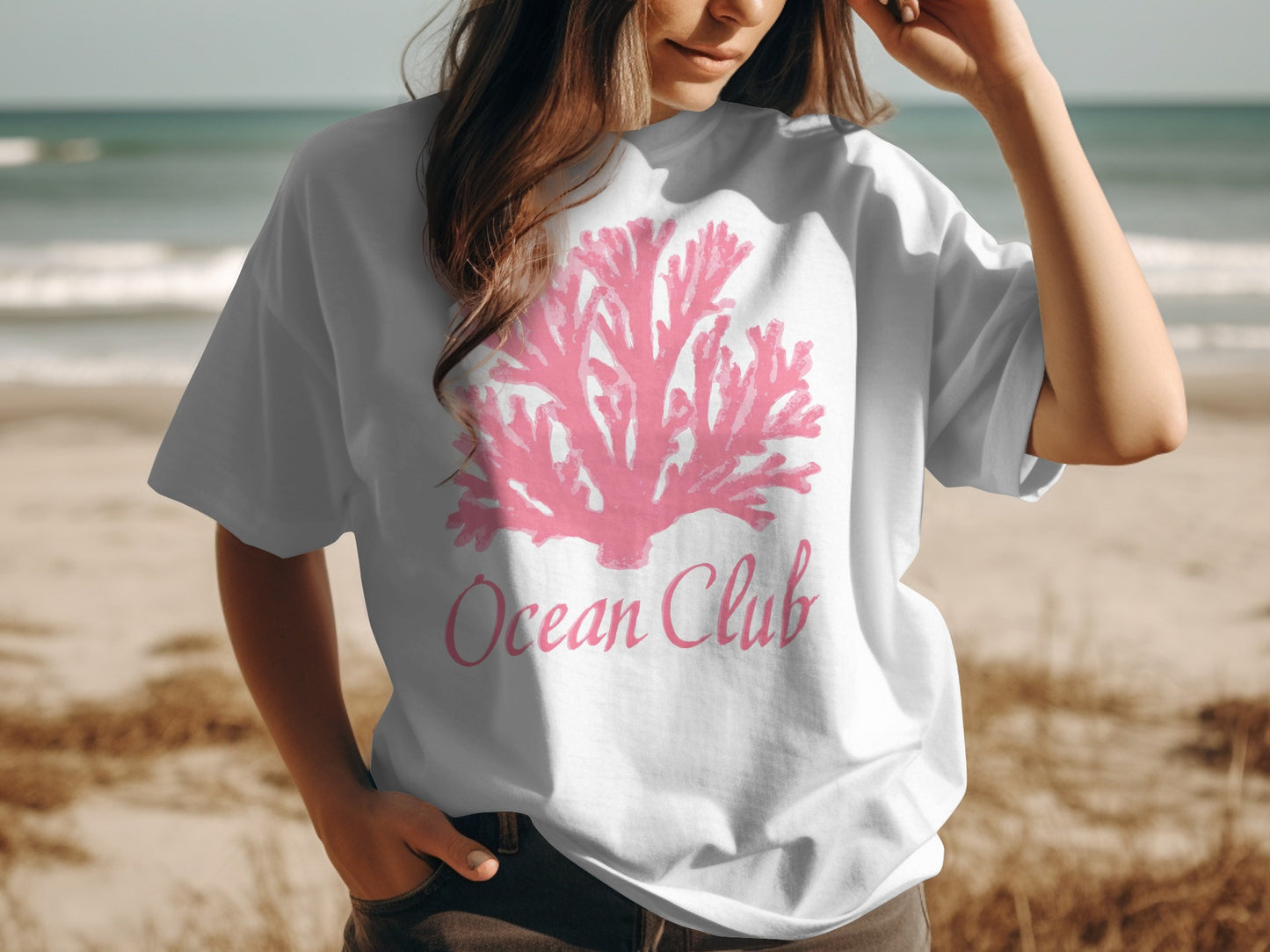 White t-shirt with pink coral graphic and "Ocean Club" text.