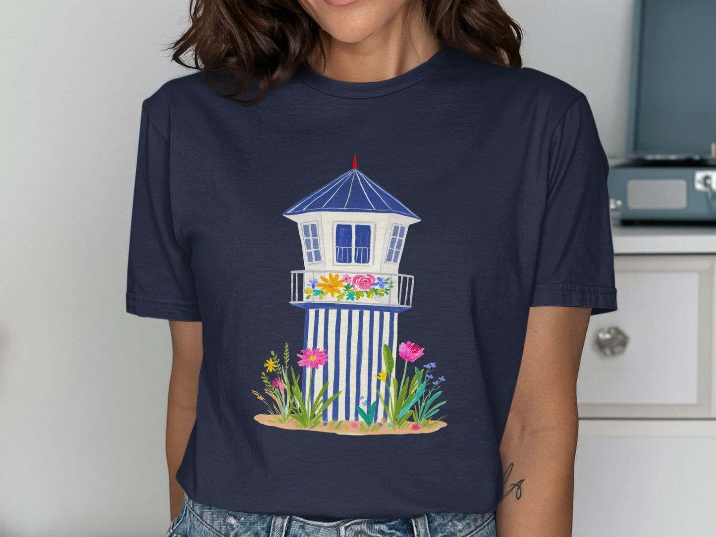 Navy t-shirt with illustration of a beach lifeguard tower with flowers.