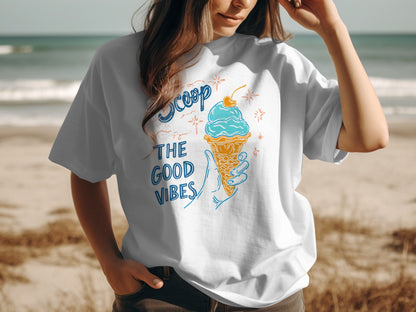 White t-shirt with "Scoop the Good Vibes" text and ice cream cone graphic.