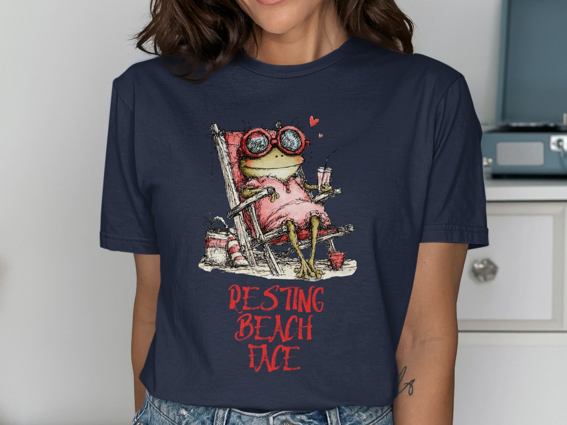 Frog in a pink dress and sunglasses relaxes in a beach chair.