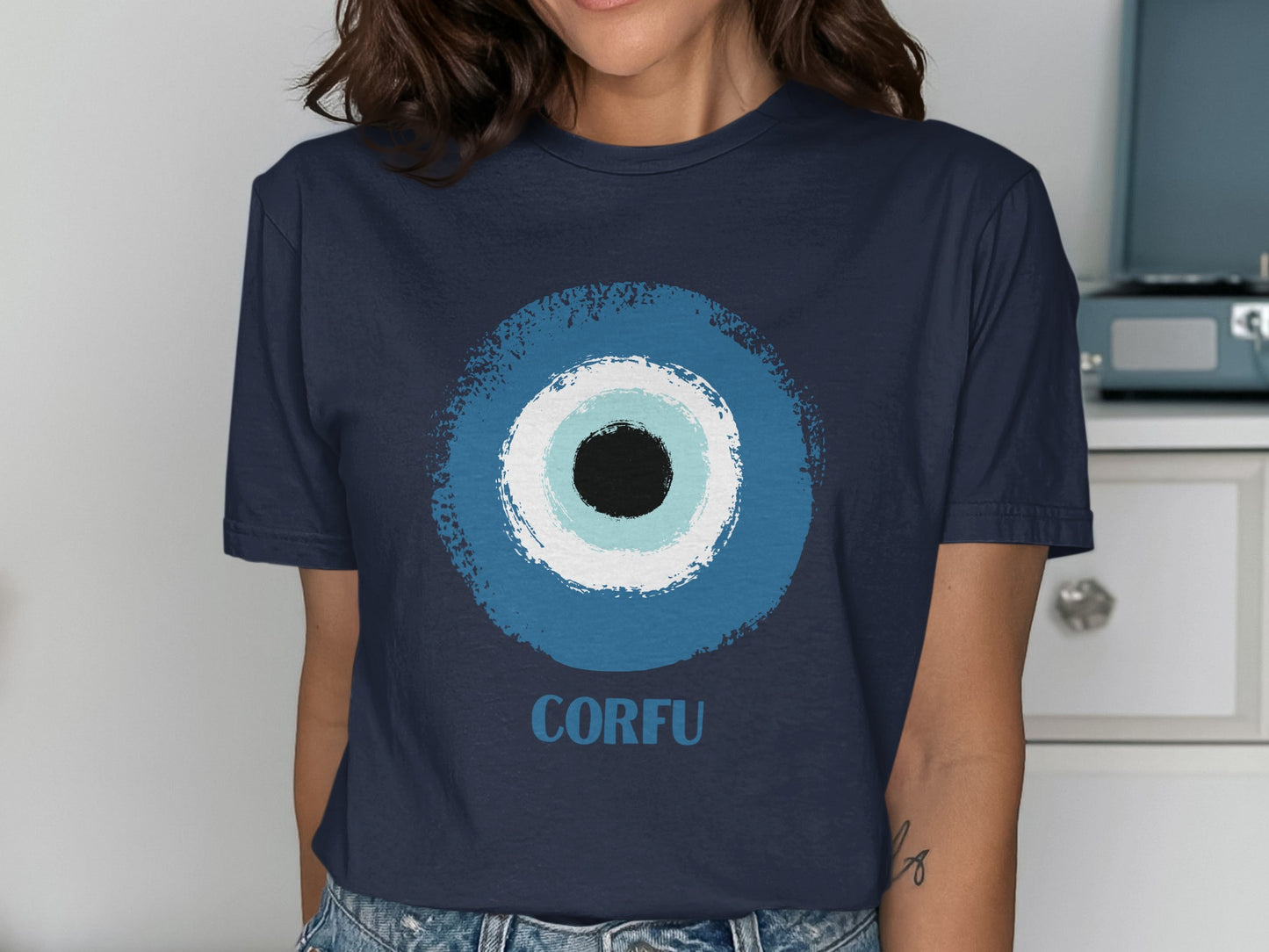 Navy t-shirt with a blue, white, and black evil eye graphic and "CORFU" text.