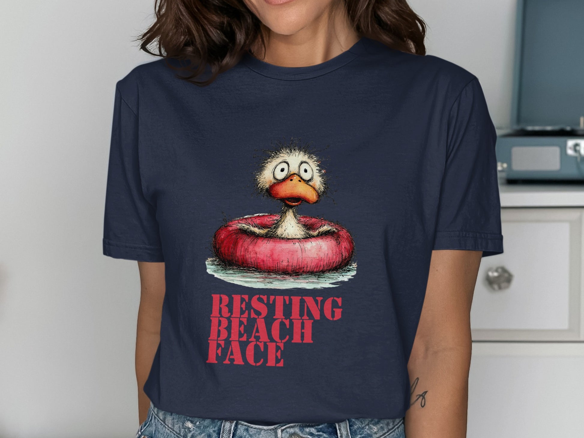 Navy t-shirt with cartoon duck in inner tube and text "RESTING BEACH FACE".
