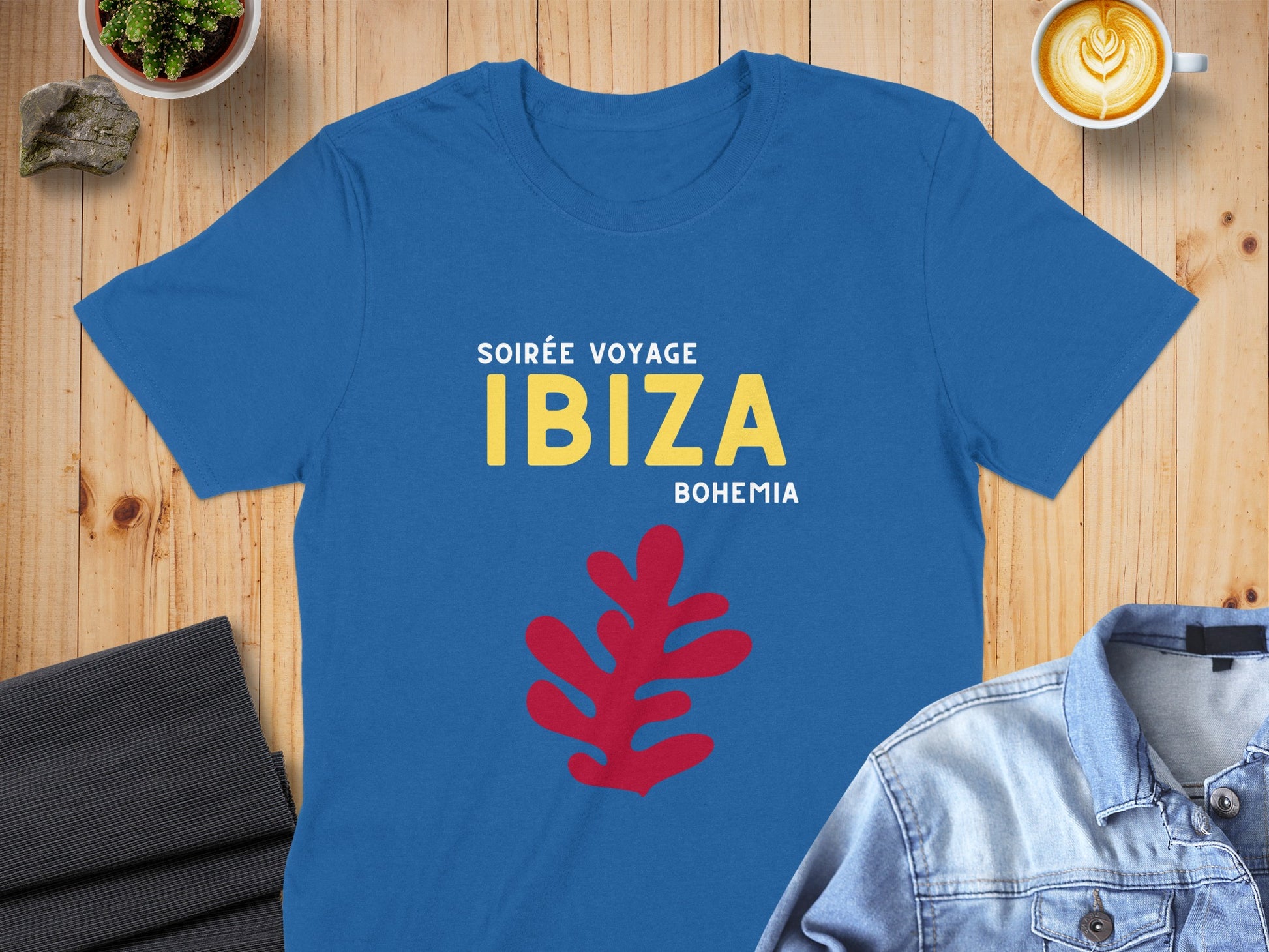 Blue t-shirt with "SOIRÉE VOYAGE IBIZA BOHEMIA" text and red abstract leaf design.