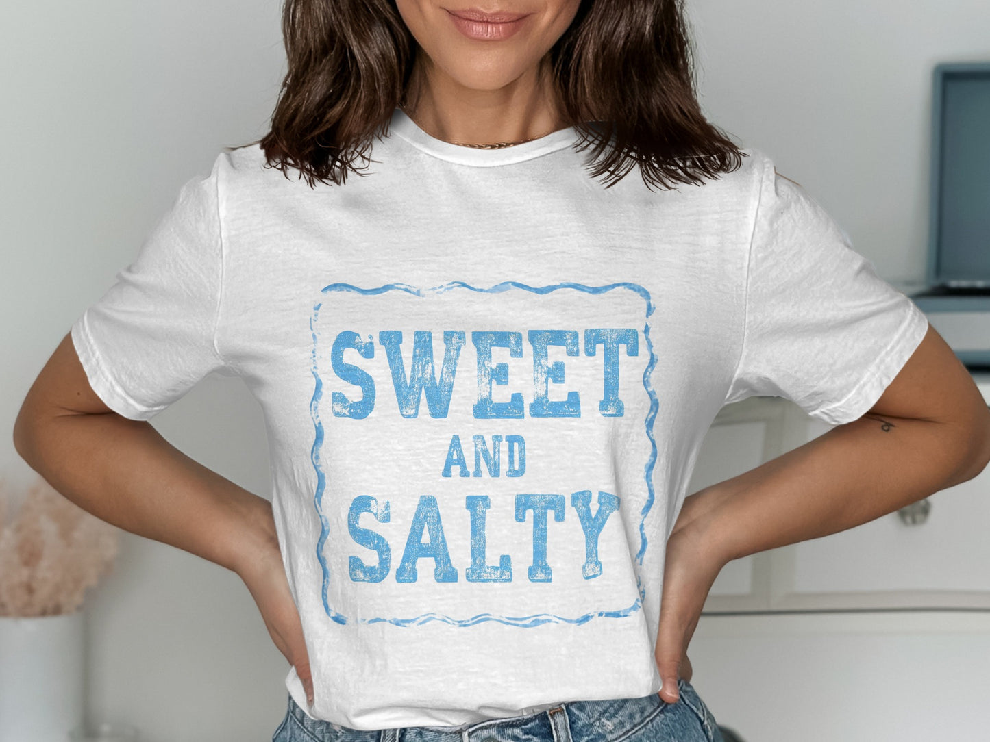 White t-shirt with "SWEET AND SALTY" text in distressed blue font.