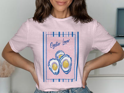 Pink t-shirt with a pastel pink graphic of three oysters and "Oyster Lover" text.