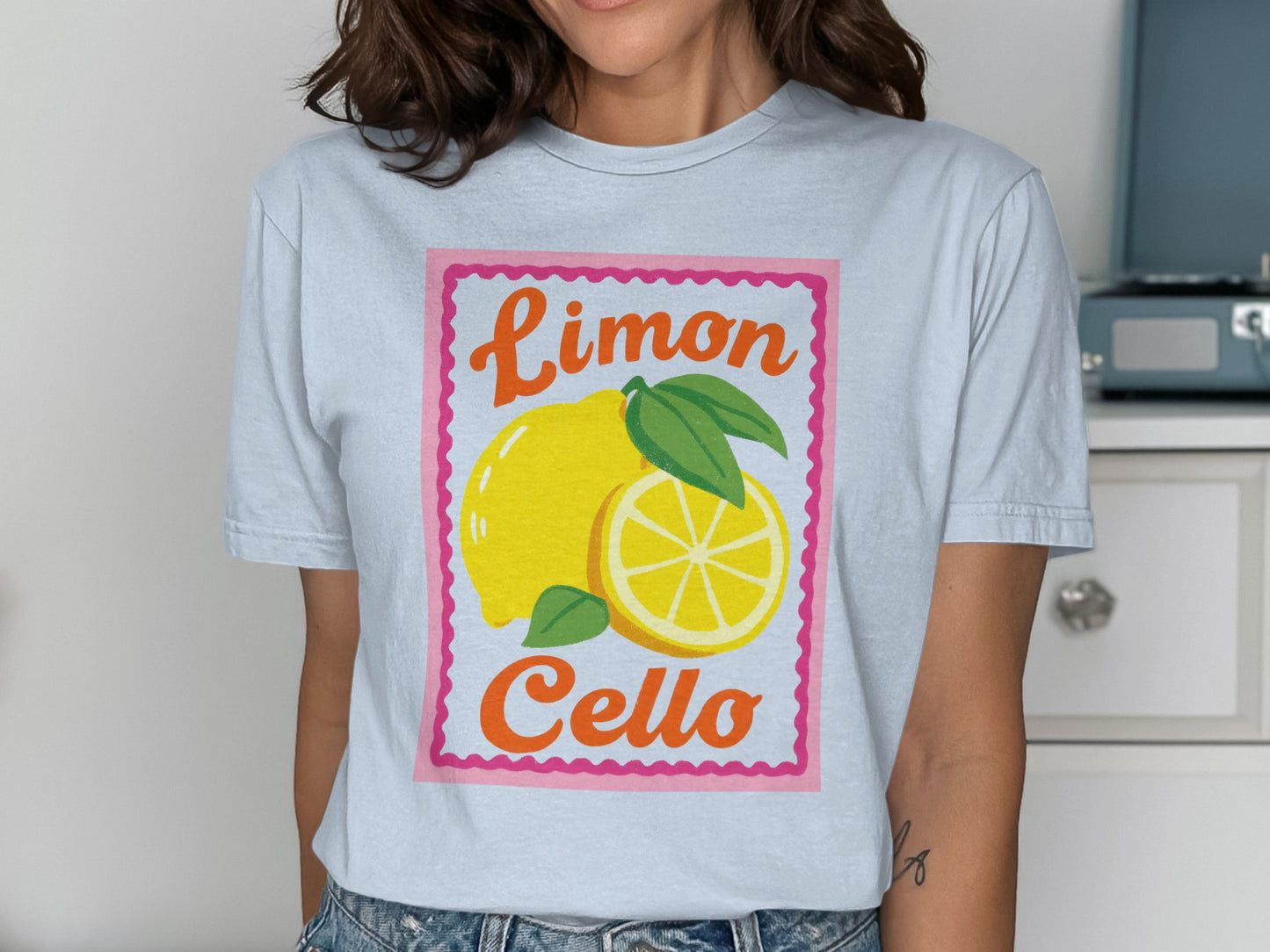Light blue t-shirt with a yellow lemon and "Limoncello" text.