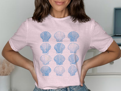 Pink t-shirt with a grid of blue seashell illustrations.
