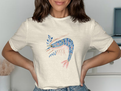 Cream t-shirt with blue shrimp and floral design.