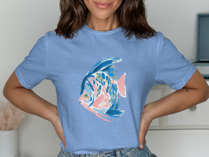 Light blue t-shirt with a stylized blue, pink, and gold fish graphic.