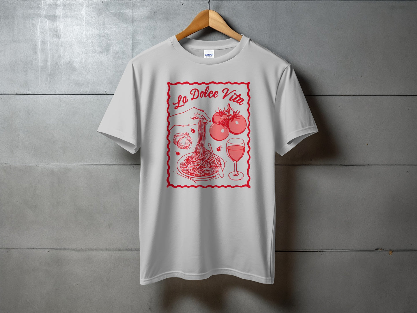 White t-shirt with "La Dolce Vita" and illustration of spaghetti, tomatoes, and wine.