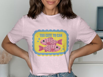 Pink t-shirt with cartoon fish and text "Too Cute to Can".