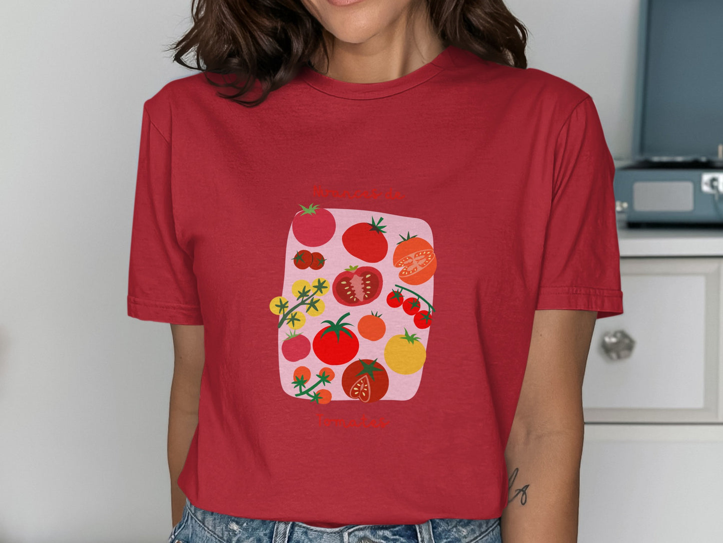 Red t-shirt with colorful cartoon tomatoes and floral accents.