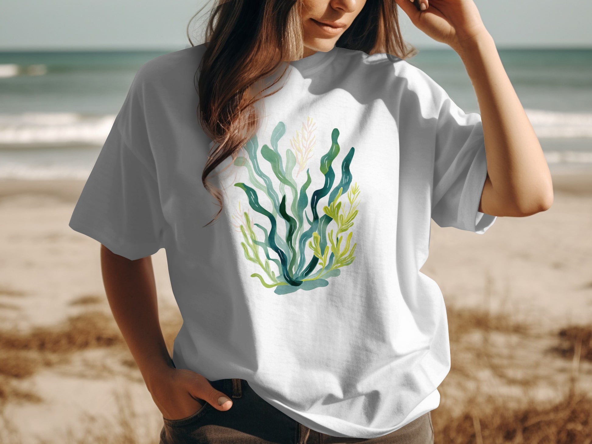 White t-shirt with a watercolor illustration of green and yellow seaweed.