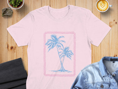 Pink t-shirt with blue palm trees in a decorative frame.