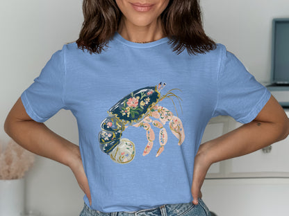 Light blue t-shirt featuring a decorative hermit crab with floral patterns.