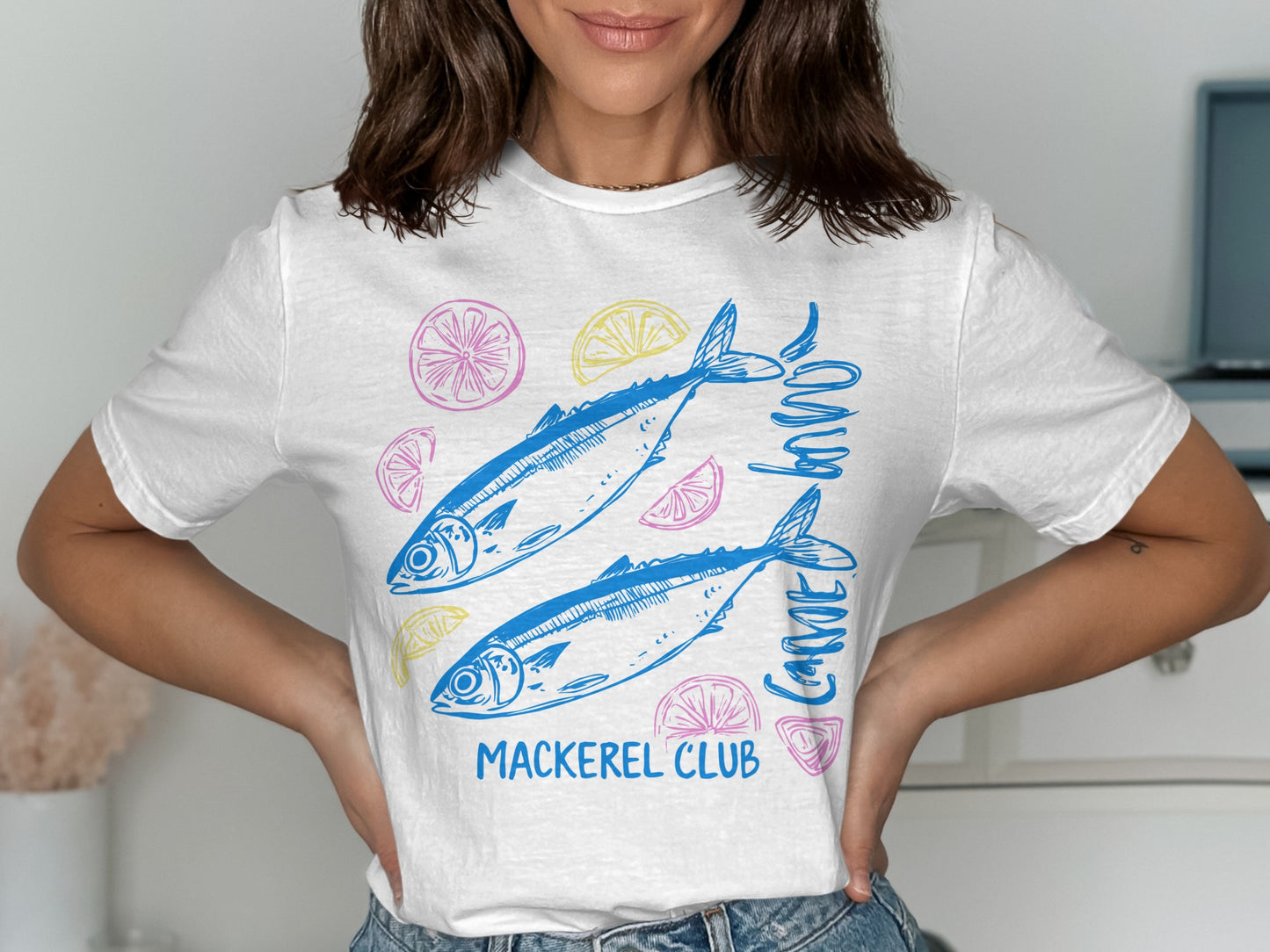 White t-shirt with blue mackerel illustration and "Mackerel Club" text.