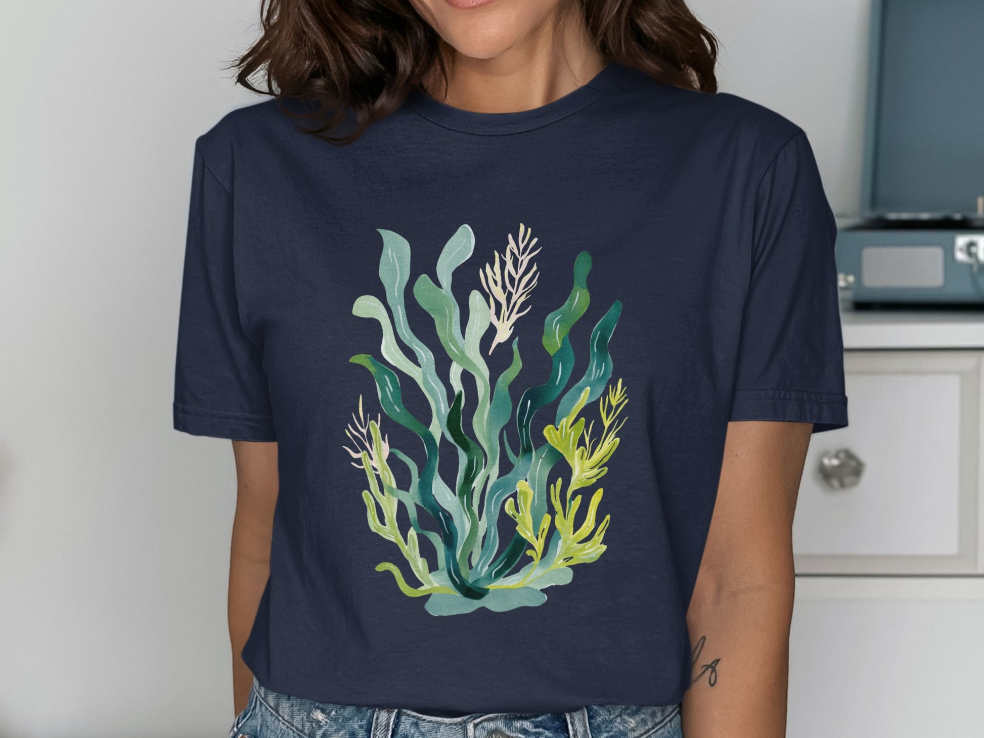 Navy t-shirt with watercolor illustration of seaweed and coral.