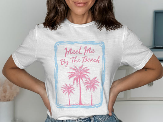 White t-shirt with pink palm trees and "Meet Me By The Beach" text.