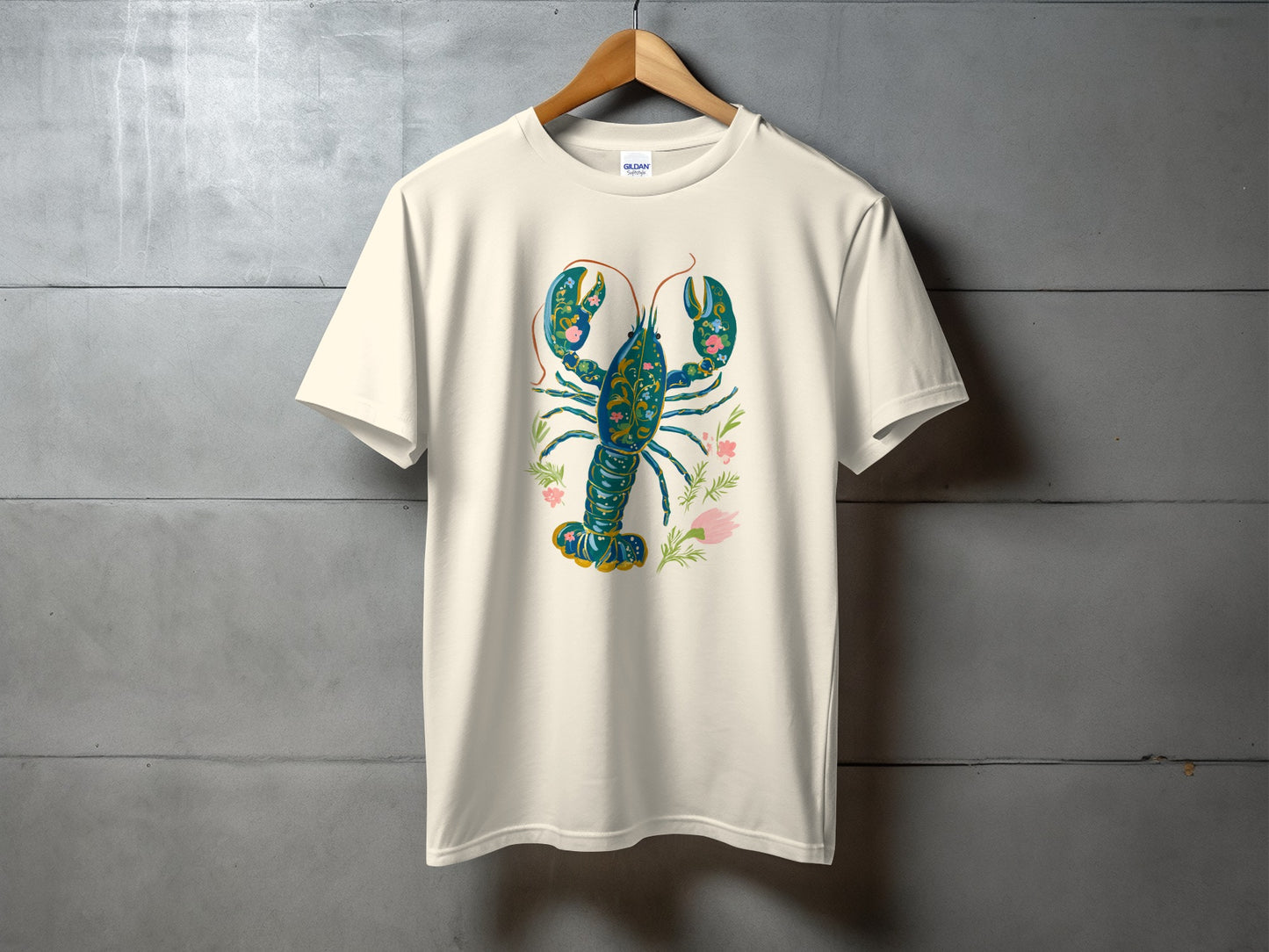 Cream t-shirt with a blue and green lobster and pink flowers design.