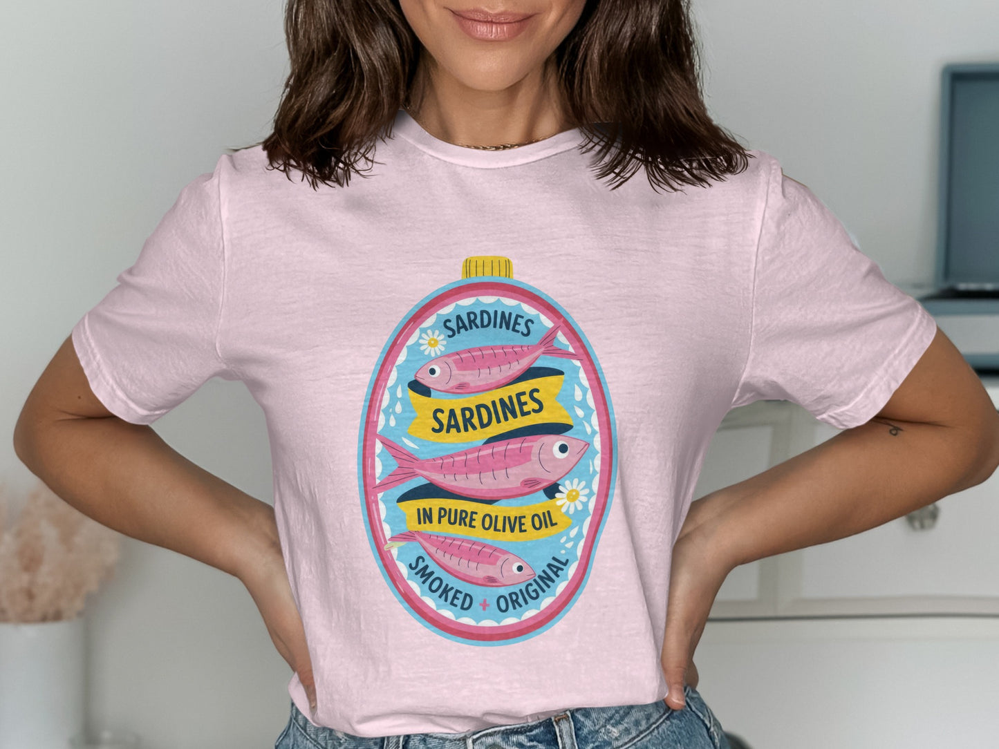 Pink t-shirt with a graphic of a vintage sardine can label.