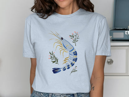 Light blue t-shirt with a watercolor-style shrimp and floral design.