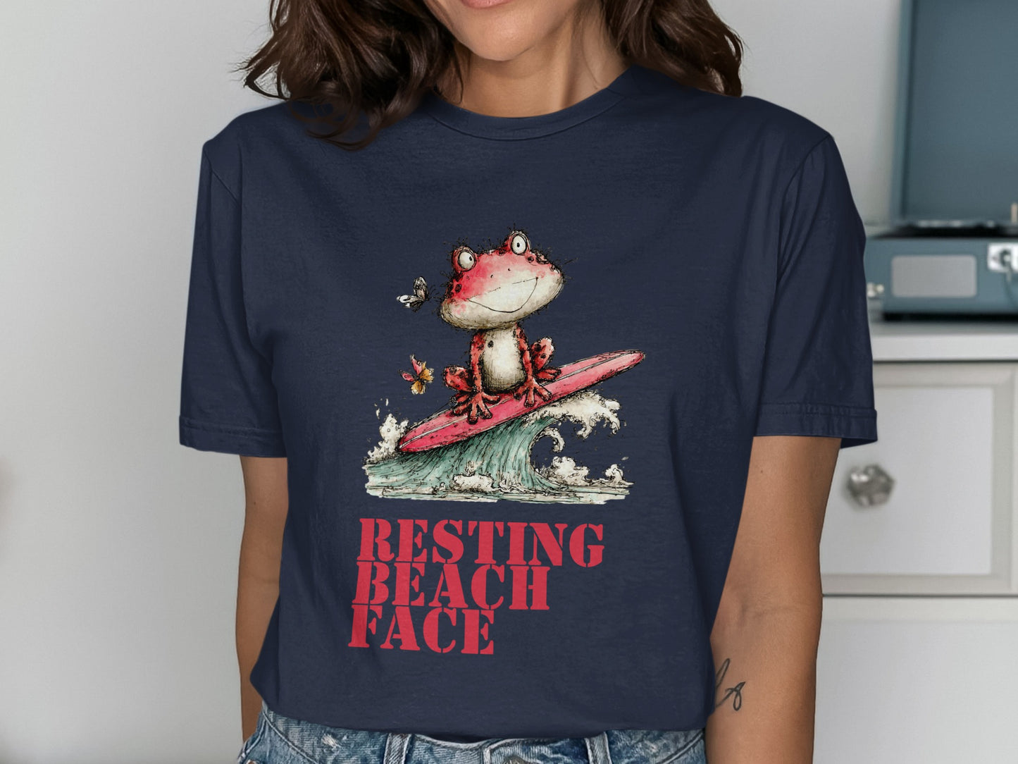 Frog surfing on a wave, text "RESTING BEACH FACE".