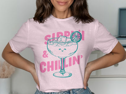 Pink t-shirt with cartoon cocktail glass, "Sippin' & Chillin'" text.