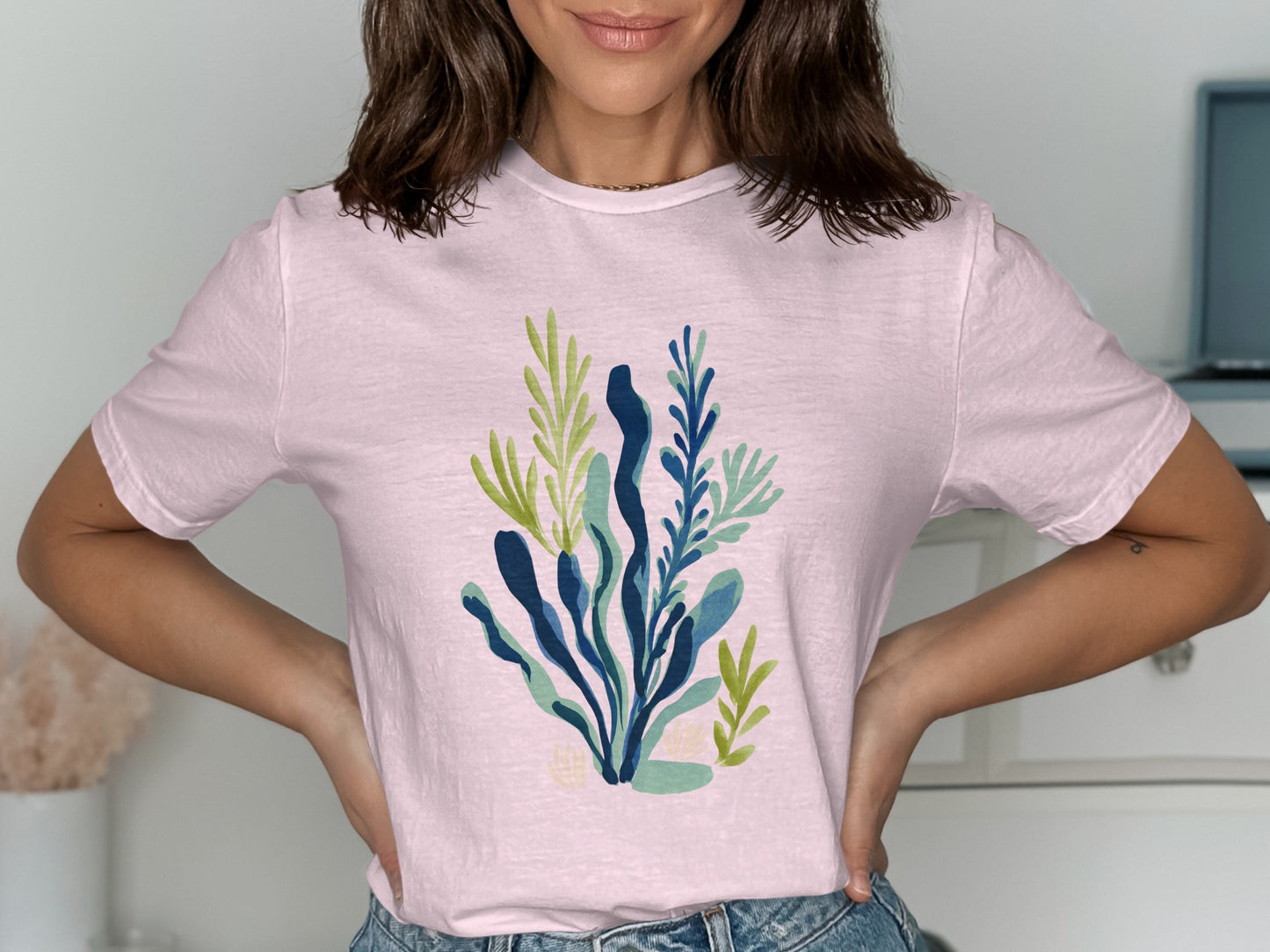 Light pink t-shirt with a blue and green abstract floral graphic.