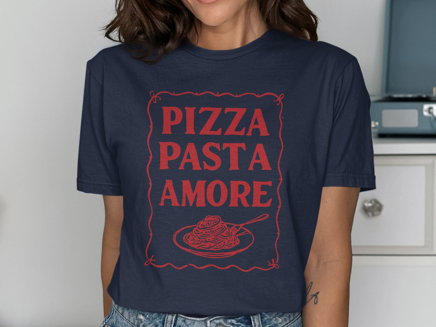 Navy t-shirt with red text "Pizza Pasta Amore" and pasta graphic.