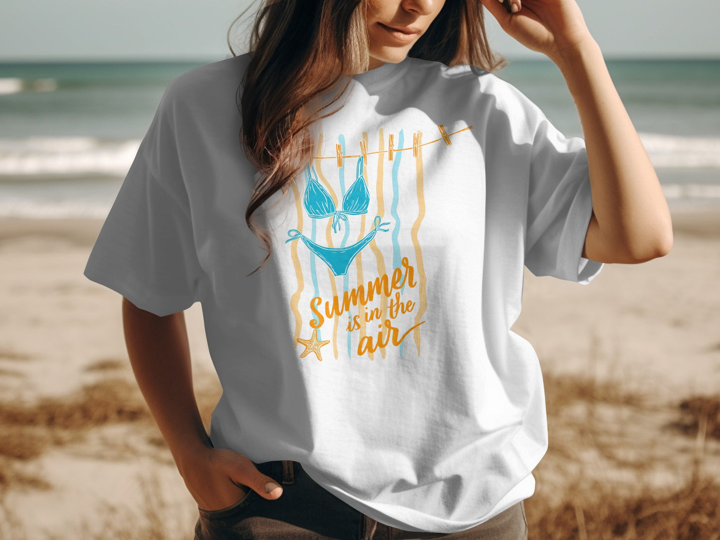 White t-shirt with blue bikini graphic and "Summer is in the air" text.