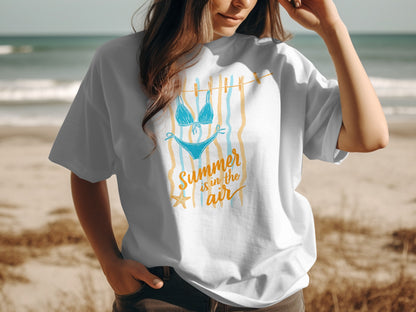White t-shirt with blue bikini graphic and "Summer is in the air" text.