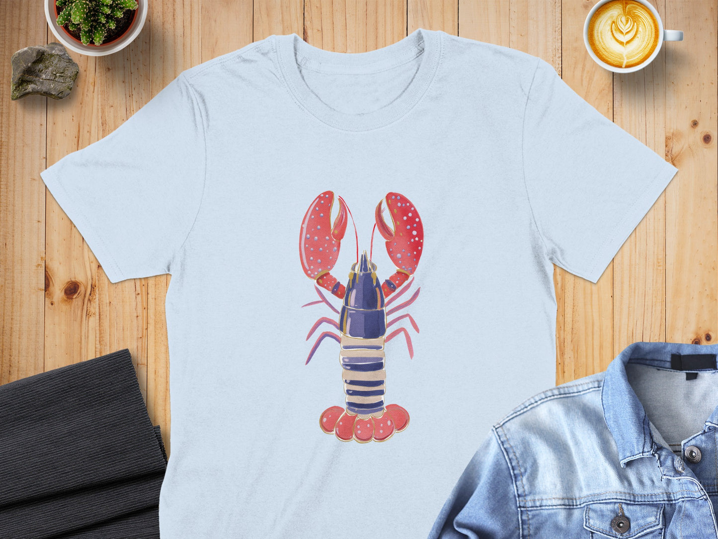 Light blue t-shirt featuring a cartoon lobster graphic.