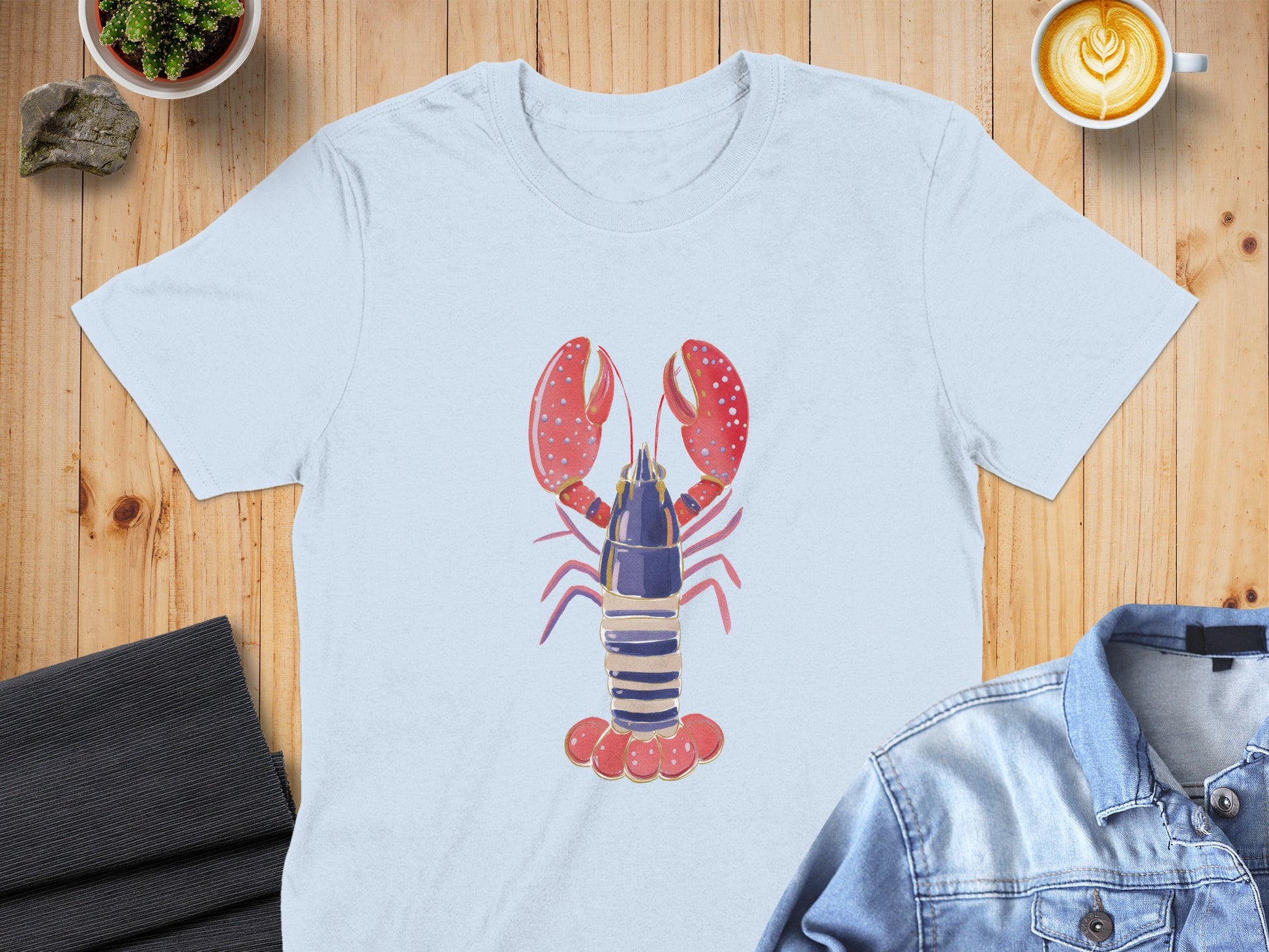 Light blue t-shirt featuring a cartoon lobster graphic.