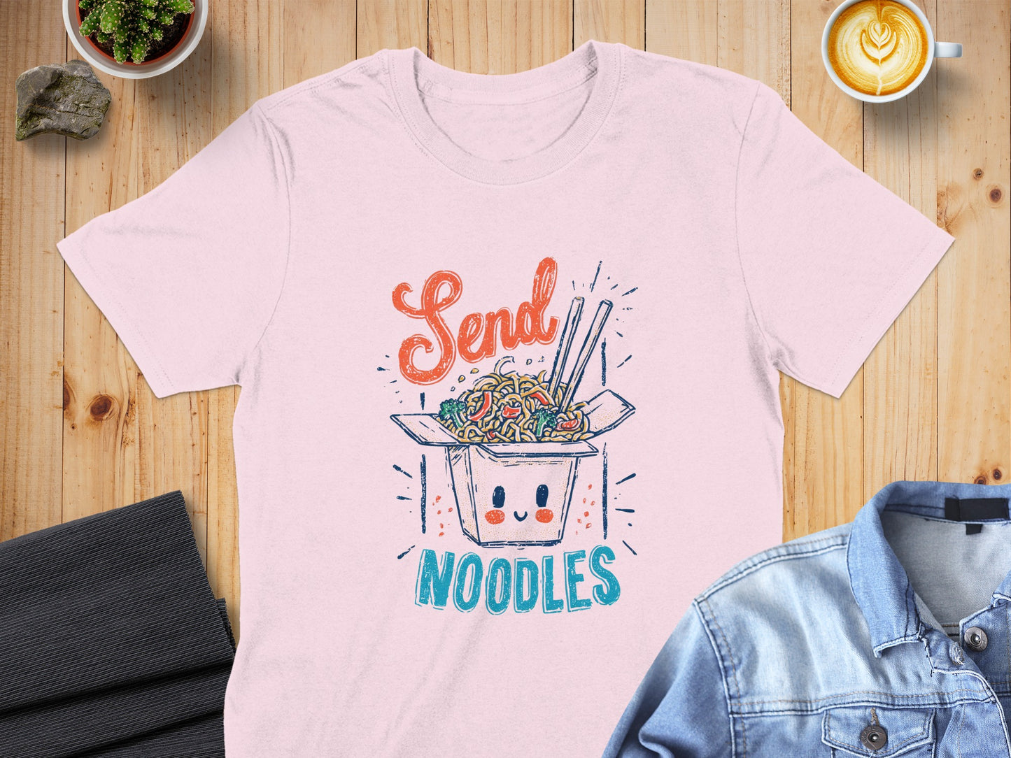 Pink t-shirt with "Send Noodles" text and cartoon takeout box graphic.