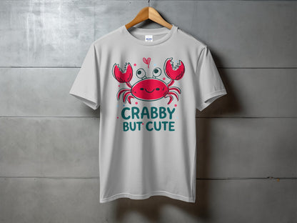White t-shirt with a cartoon crab saying "Crabby But Cute".