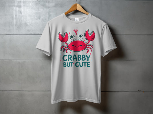 White t-shirt with a cartoon crab saying "Crabby But Cute".