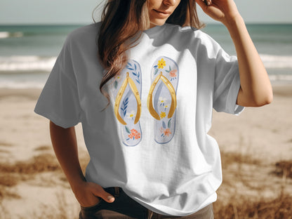 White t-shirt with a watercolor design of flip-flops and flowers.