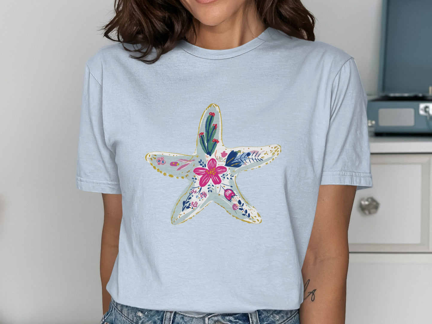 Light blue t-shirt with a floral starfish graphic.